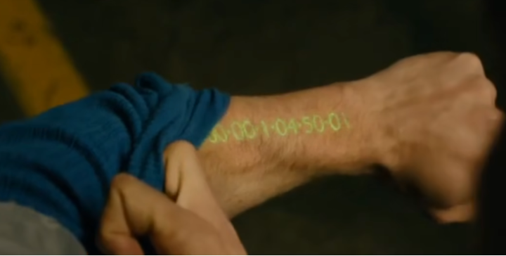 A token clock projected onto a person's wrist